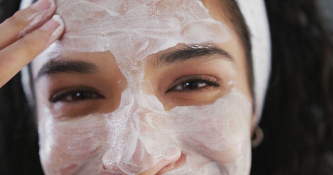 Woman Applying Skincare Mask with a Smile - Free Images, Stock Photos and Pictures on Pikwizard.com