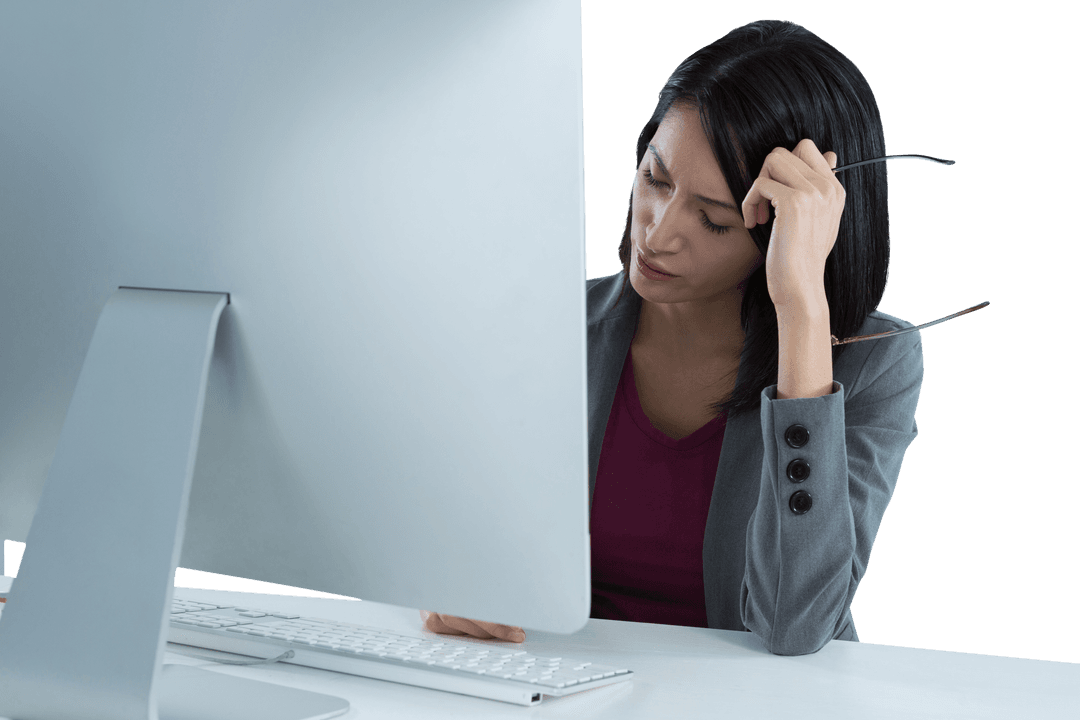 Exhausted Businesswoman at Desk Working on Large Monitor