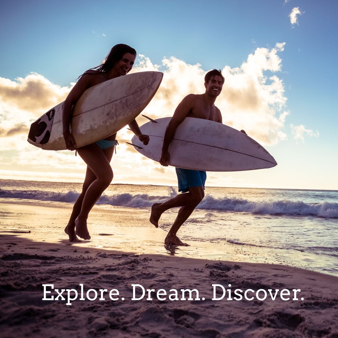 Couple Joyfully Surfing at Sunset on Coastal Adventure