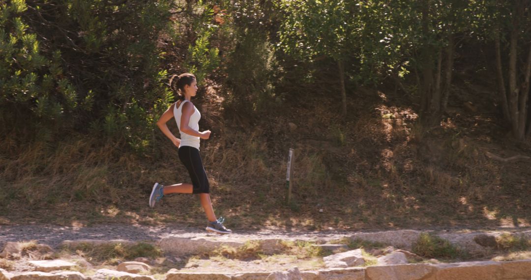 Woman Jogging Outdoors on Narrow Trail in Forest Setting - Free Images, Stock Photos and Pictures on Pikwizard.com