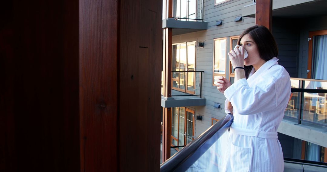 Relaxed Woman in Bathrobe Drinking Coffee on Hotel Balcony - Free Images, Stock Photos and Pictures on Pikwizard.com