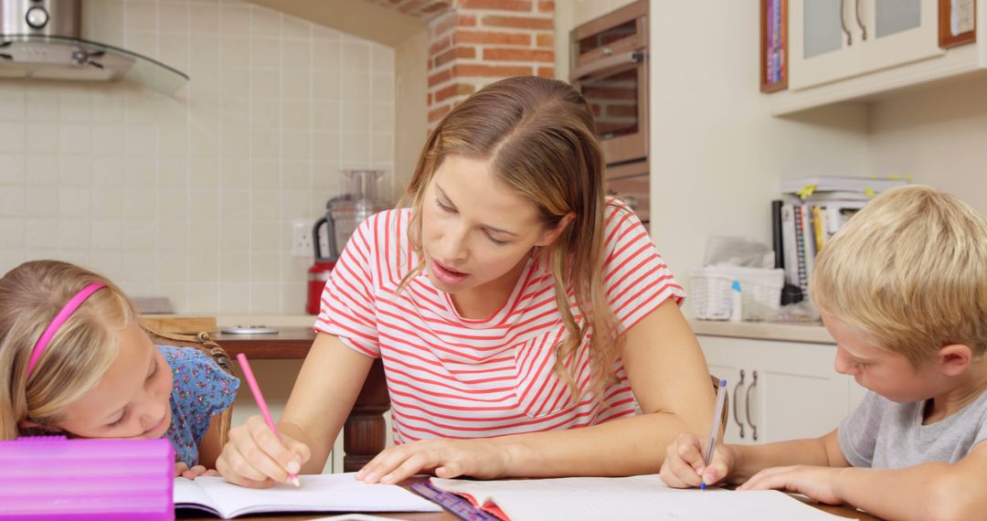 Mother Helping Children with Homework at Kitchen Table - Free Images, Stock Photos and Pictures on Pikwizard.com