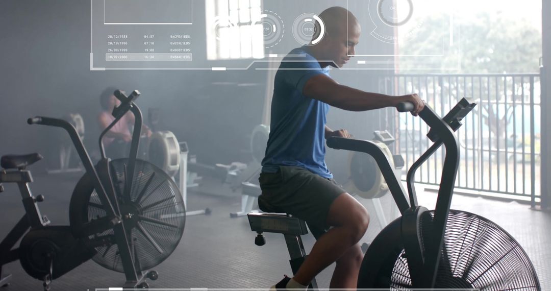 Digital Interface Tracking Biracial Man Exercising on Elliptical Bike in Gym
