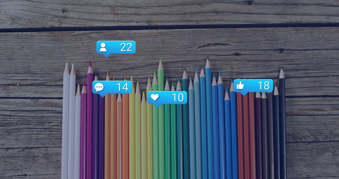 Vibrant Colored Pencils with Social Media Engagement Icons on Wooden Background