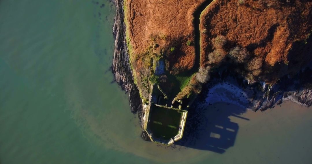 Stunning Aerial View of Ruined Coastal Structure on Cliff Edge - Free Images, Stock Photos and Pictures on Pikwizard.com