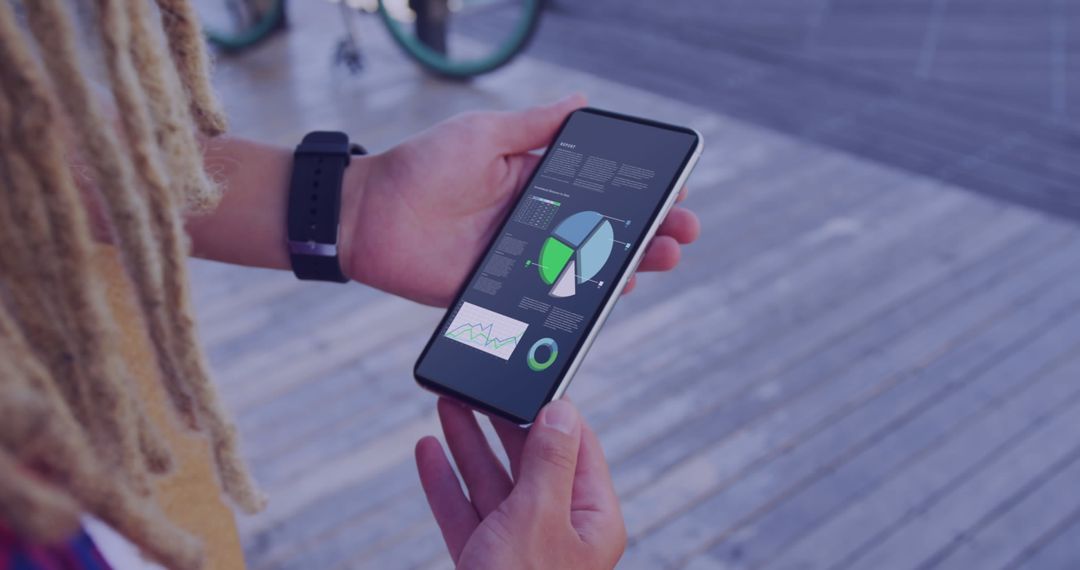 Person Analyzing Stock Market Charts on Smartphone