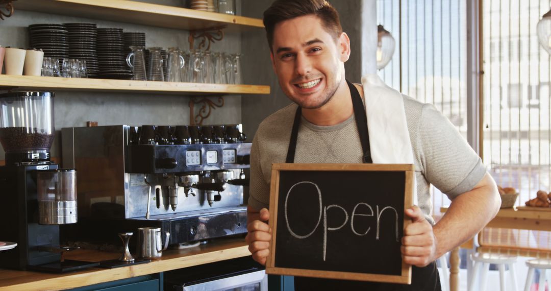 Cheerful Barista Holding Open Sign in Café - Free Images, Stock Photos and Pictures on Pikwizard.com