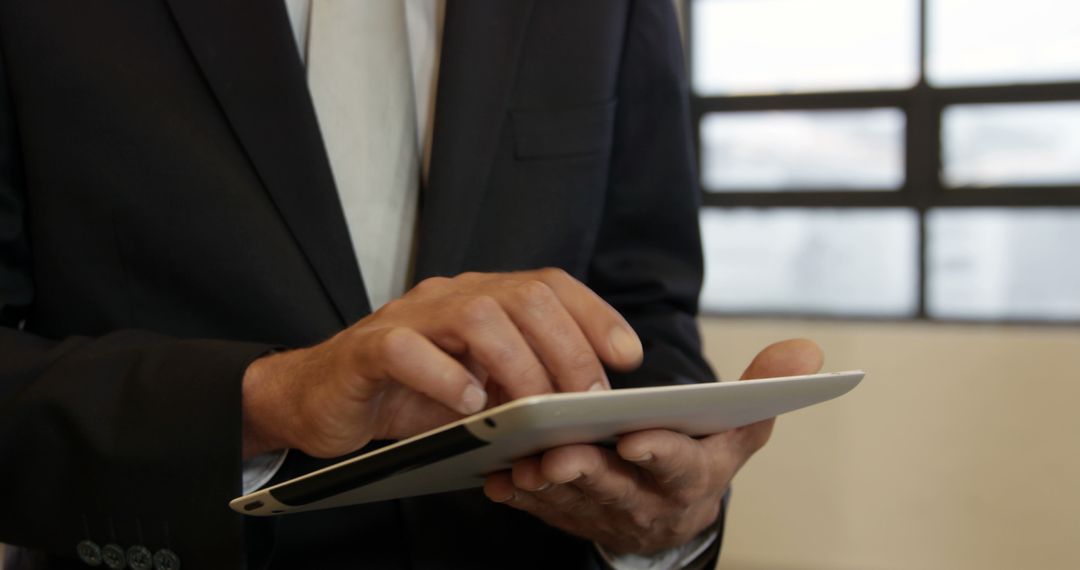 Businessman Using Digital Tablet in Office Environment - Free Images, Stock Photos and Pictures on Pikwizard.com