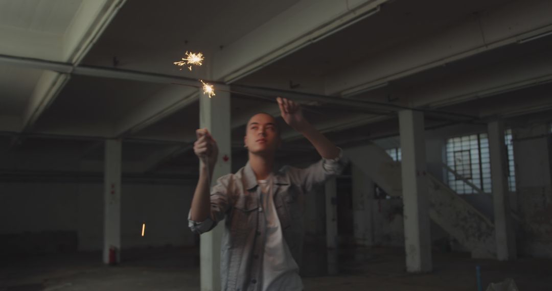 Young Man Holding Sparklers Celebrating Indoors - Free Images, Stock Photos and Pictures on Pikwizard.com