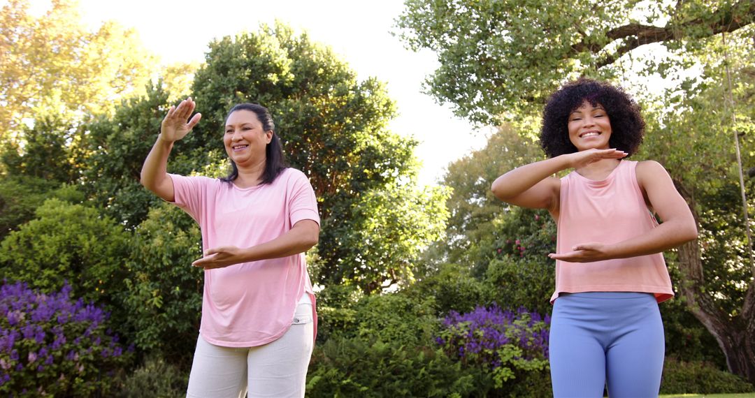 Mother and Daughter Practicing Tai Chi in Park for Relaxation