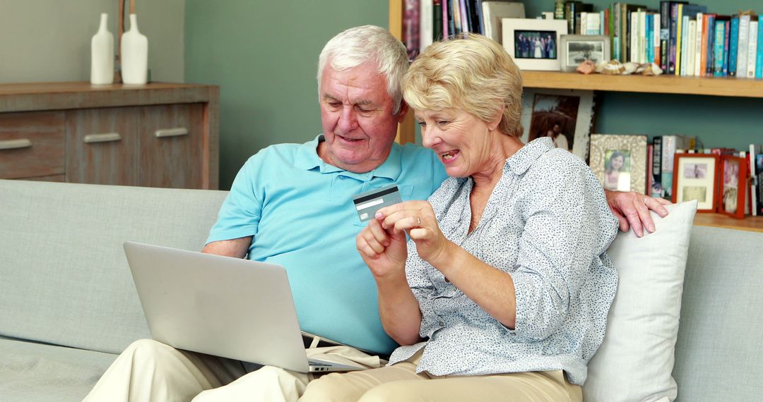 Senior Couple Shopping Online with Credit Card on Cozy Couch