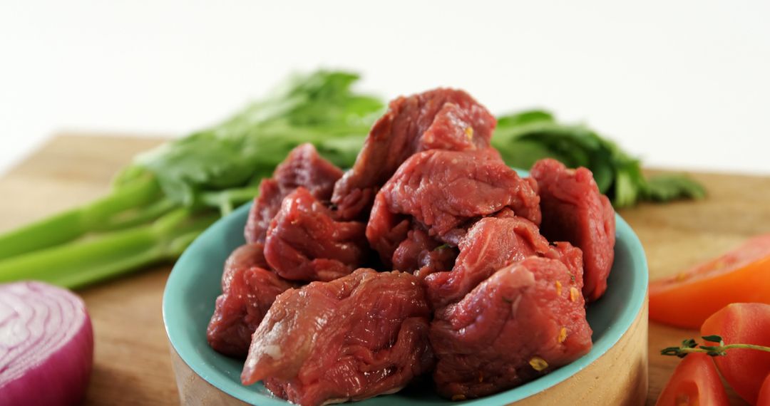 Fresh Raw Beef Cubes in Blue Bowl on Cutting Board - Free Images, Stock Photos and Pictures on Pikwizard.com