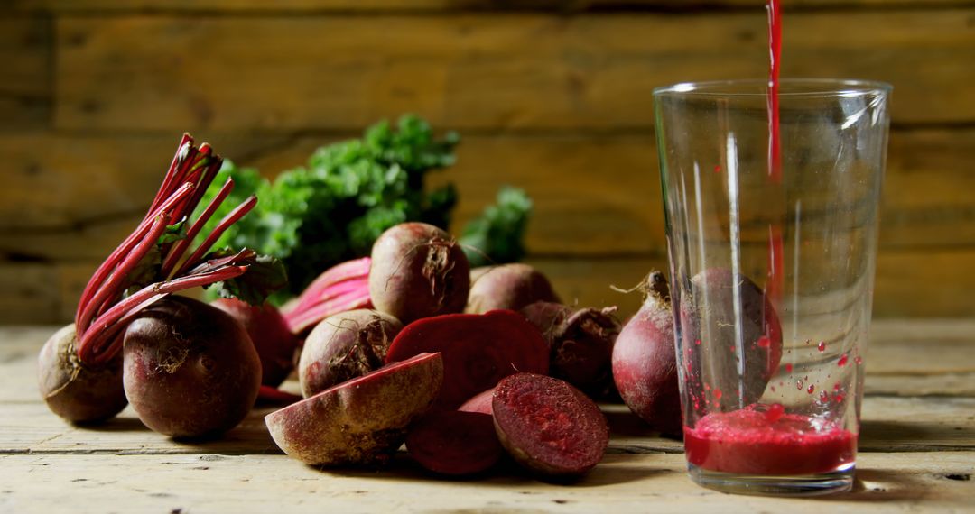 Fresh Beet Juice Pouring Into Glass With Beetroots on Wooden Table - Free Images, Stock Photos and Pictures on Pikwizard.com