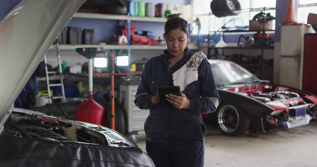 Female Mechanic Using Tablet in Auto Repair Shop - Free Images, Stock Photos and Pictures on Pikwizard.com