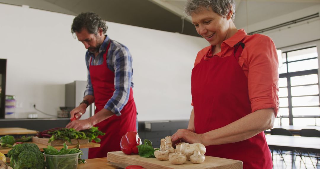 Smiling Seniors Preparing Fresh Vegetables in Kitchen