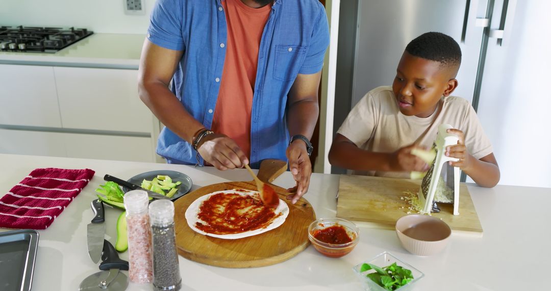 Father and Son Making Pizza at Kitchen Island Combinatively