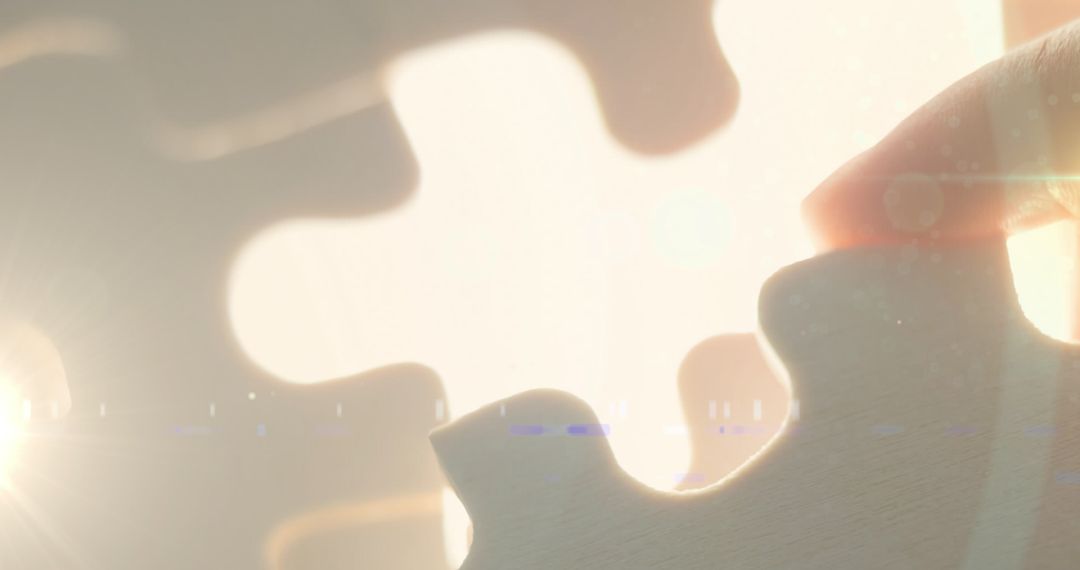 Hand Placing Puzzle Piece in Soft Light