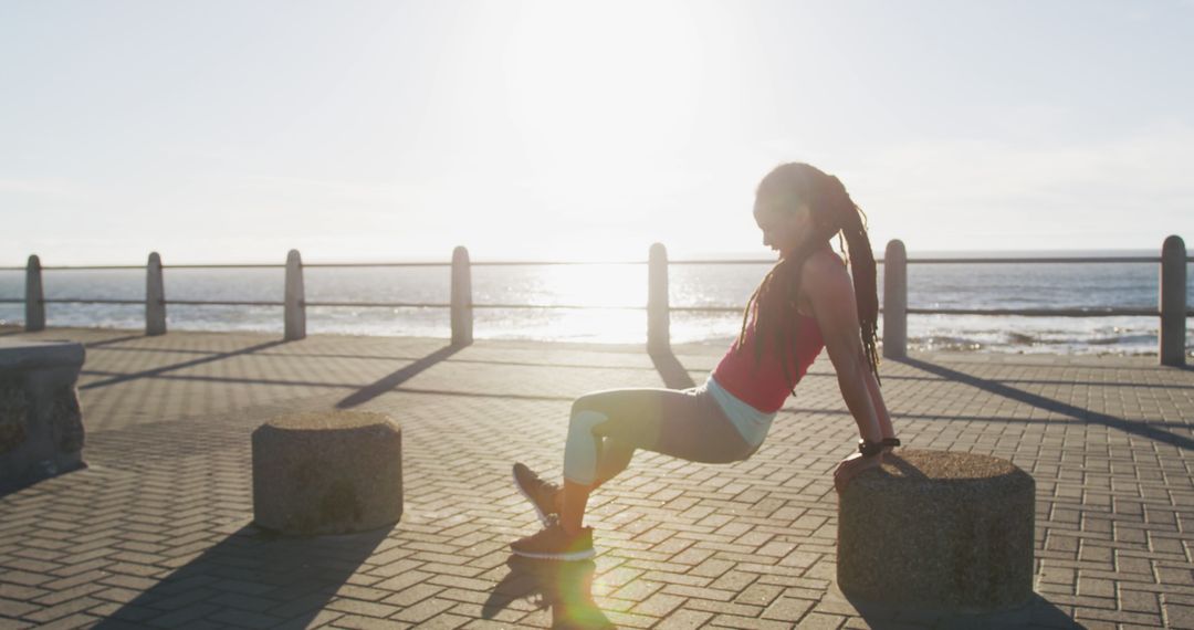 Fit woman exercising outdoors during sunset near the seaside - Free Images, Stock Photos and Pictures on Pikwizard.com