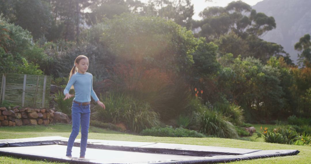 Young Girl Bouncing on Trampoline in Scenic Backyard - Free Images, Stock Photos and Pictures on Pikwizard.com