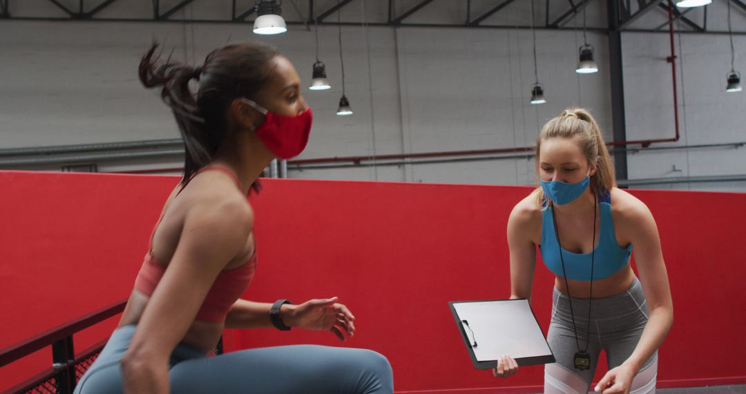 Women Exercising and Coaching in Indoor Gym While Wearing Face Masks - Free Images, Stock Photos and Pictures on Pikwizard.com