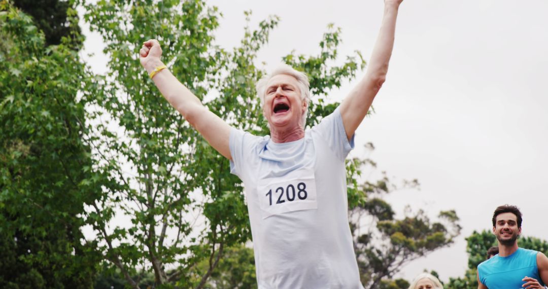 Senior Male Runner Winning Outdoor Marathon with Arms Lifted in Triumph - Free Images, Stock Photos and Pictures on Pikwizard.com