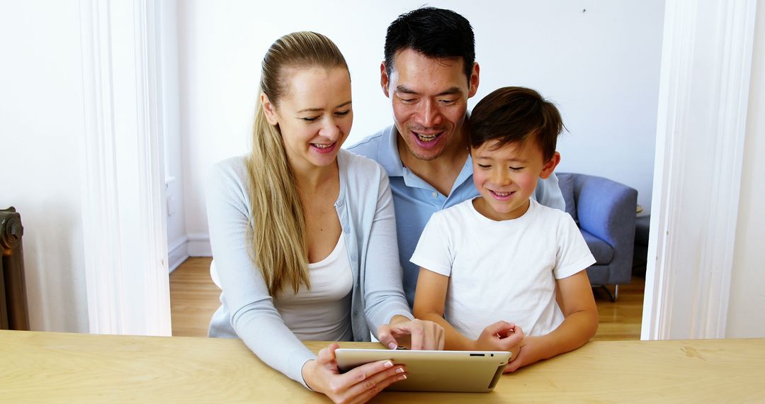 Mixed Ethnicity Family Using Tablet Together at Home - Free Images, Stock Photos and Pictures on Pikwizard.com