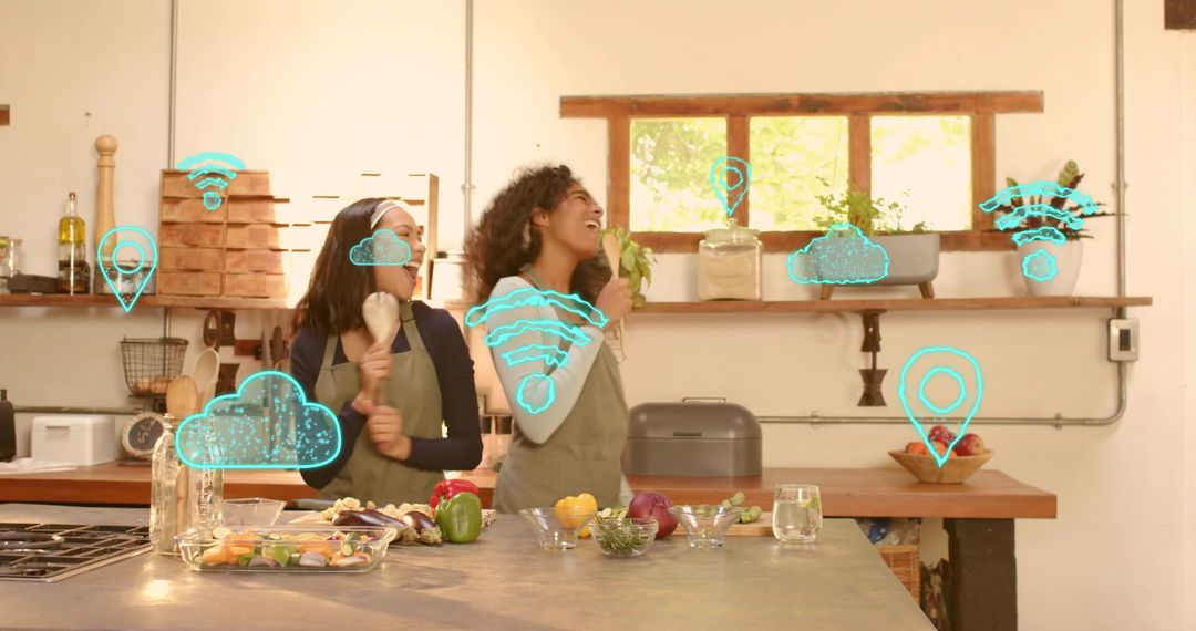 Laughing women cooking together using augmented reality icons in sunlit modern kitchen