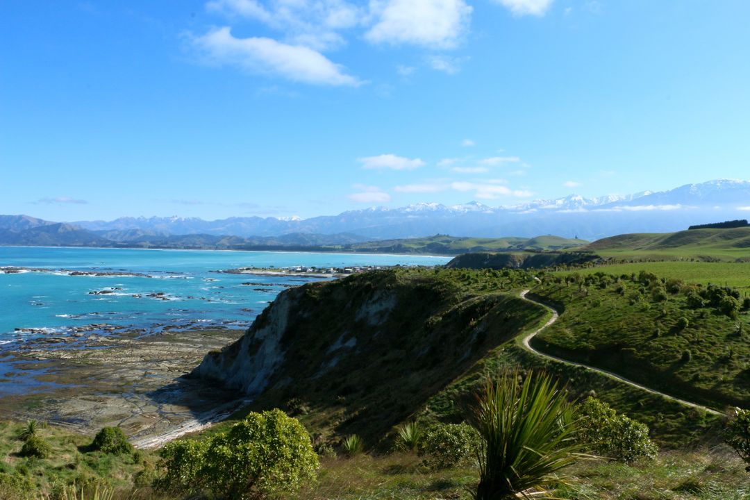 Scenic Coastal Landscape with Blue Water and Green Hills - Free Images, Stock Photos and Pictures on Pikwizard.com