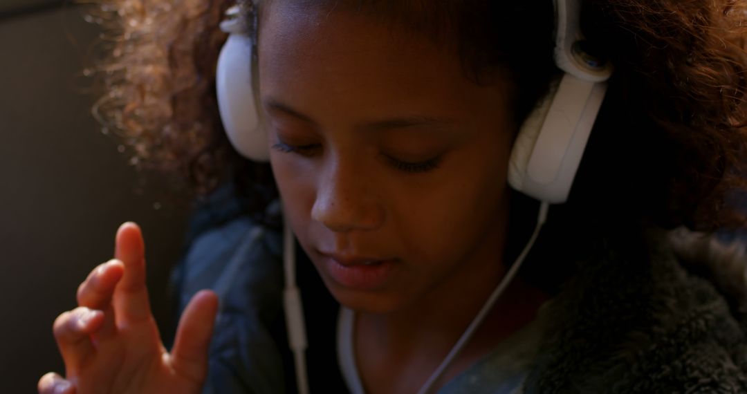 Child Relaxing With Headphones and Listening to Music - Free Images, Stock Photos and Pictures on Pikwizard.com