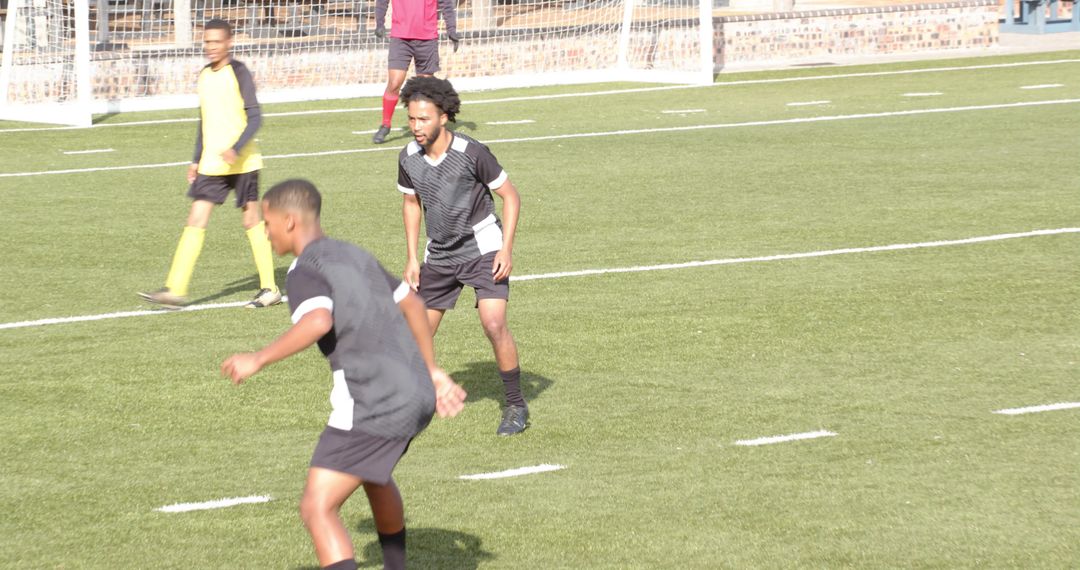 Energetic Youth Soccer Players on Field in Competitive Game