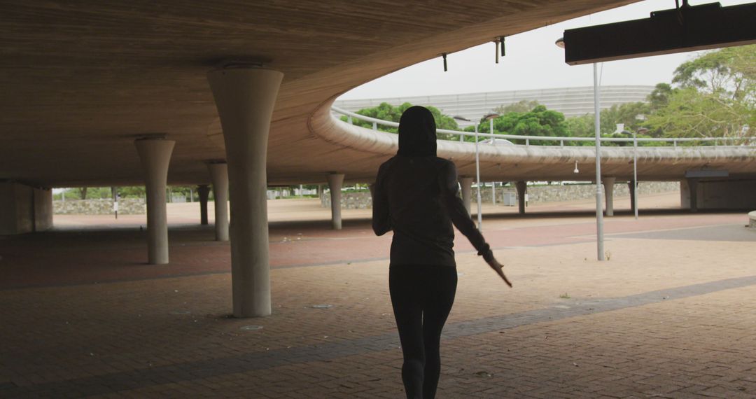 Woman Jogging Under Modern Urban Bridge in City Park - Free Images, Stock Photos and Pictures on Pikwizard.com