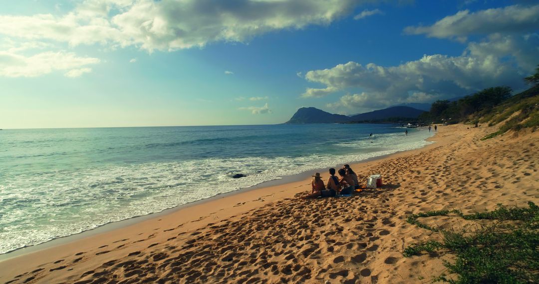 Diverse Couple Enjoying Picnic on Tranquil Sandy Beach - Free Images, Stock Photos and Pictures on Pikwizard.com