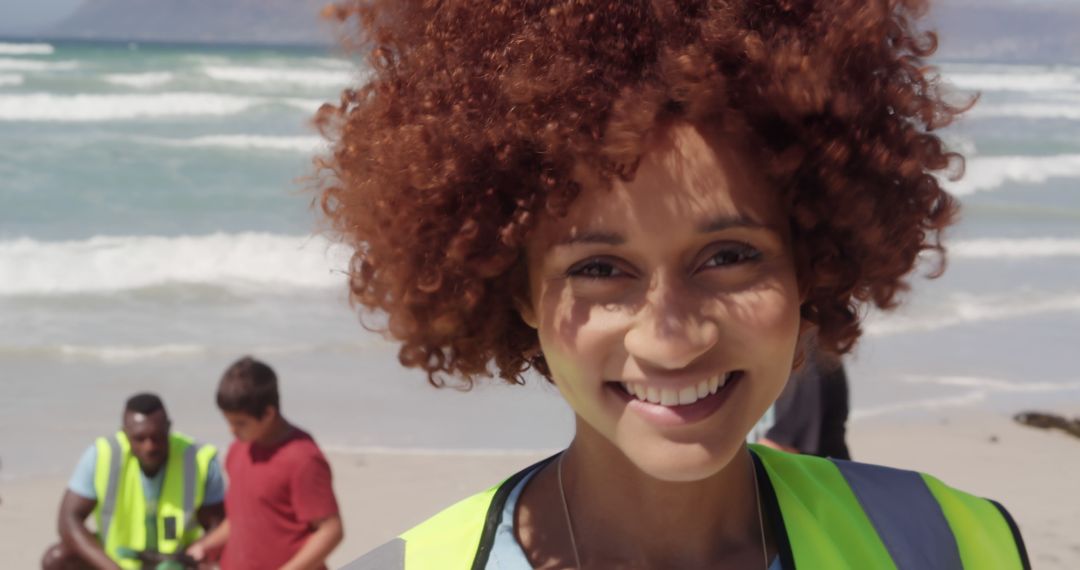 Smiling Volunteer at Beach Cleanup Event with Ocean in Background - Free Images, Stock Photos and Pictures on Pikwizard.com