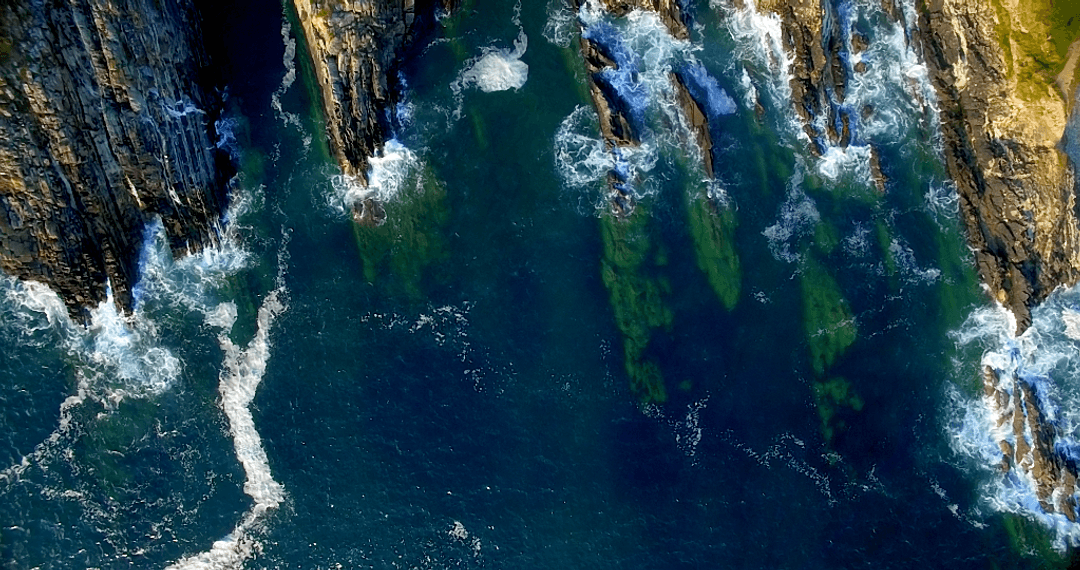 Transparent Oceanscape from Above: Rocky Sea Cliffs