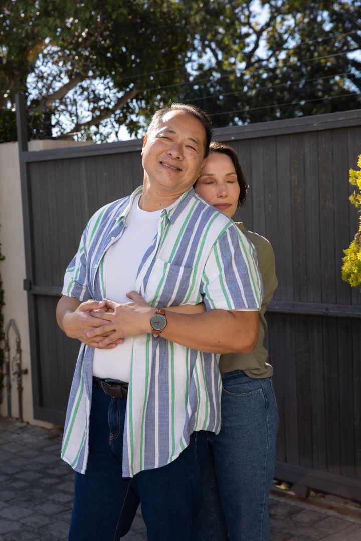 Diverse Couple Sharing an Embrace in Tranquil Outdoor Setting