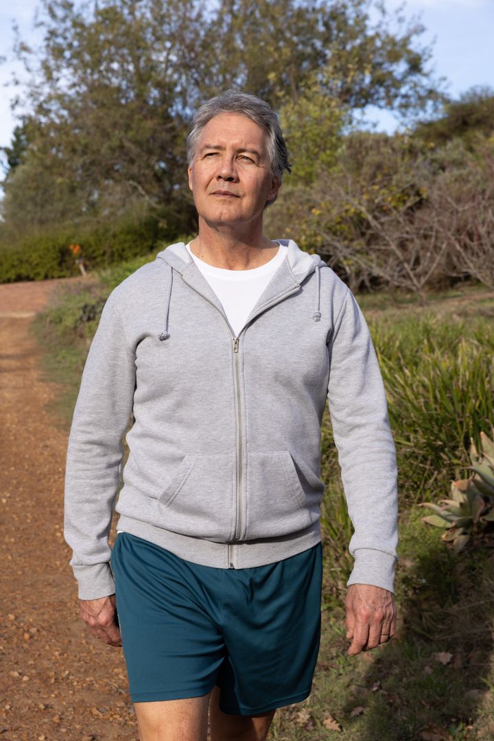 Senior Man Walking on Nature Trail Wearing Comfortable Attire