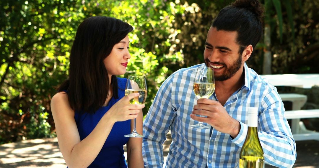Couple Toasting Wine Outdoors in Relaxed Setting