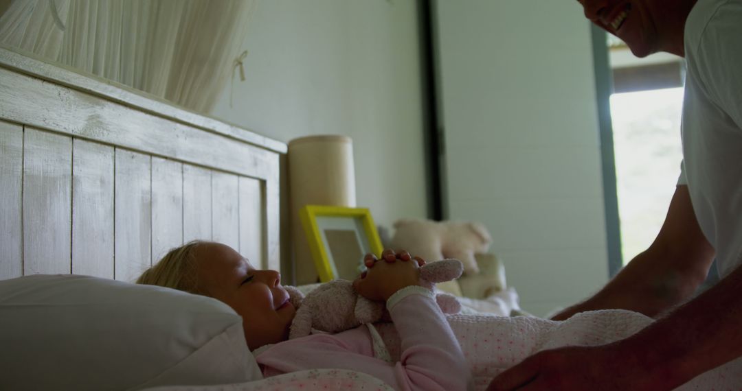 Father Tucking Daughter into Bed with Plush Toy - Free Images, Stock Photos and Pictures on Pikwizard.com