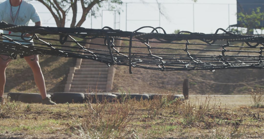 Training Instructor Readies Obstacle Crawl Nets Outdoor