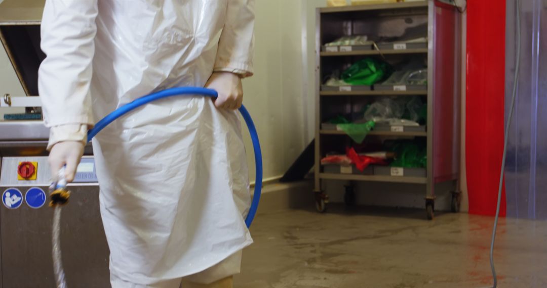 Worker Cleaning Industrial Kitchen Floor with Hose - Free Images, Stock Photos and Pictures on Pikwizard.com