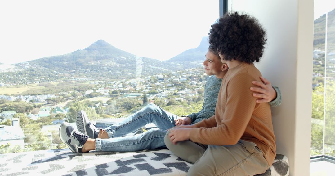 Father and Son Embracing in Scenic Modern Home
