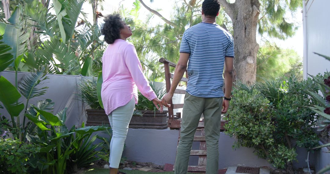 Couple's Romantic Proposal Moment with Lush Greenery Backdrop