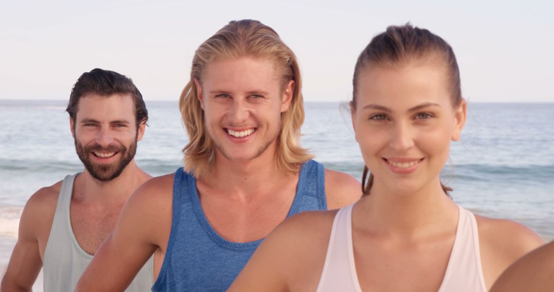 Young Adults Smiling at Beach Enjoying Leisure Time