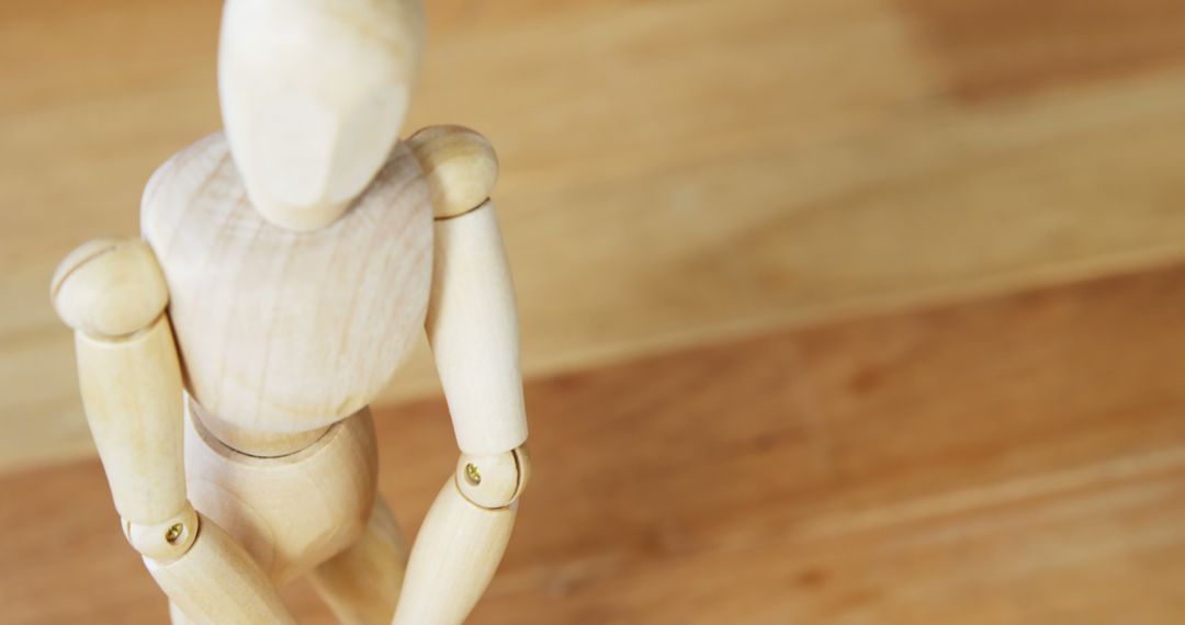 Wooden Art Mannequin Posing on Wooden Background - Free Images, Stock Photos and Pictures on Pikwizard.com