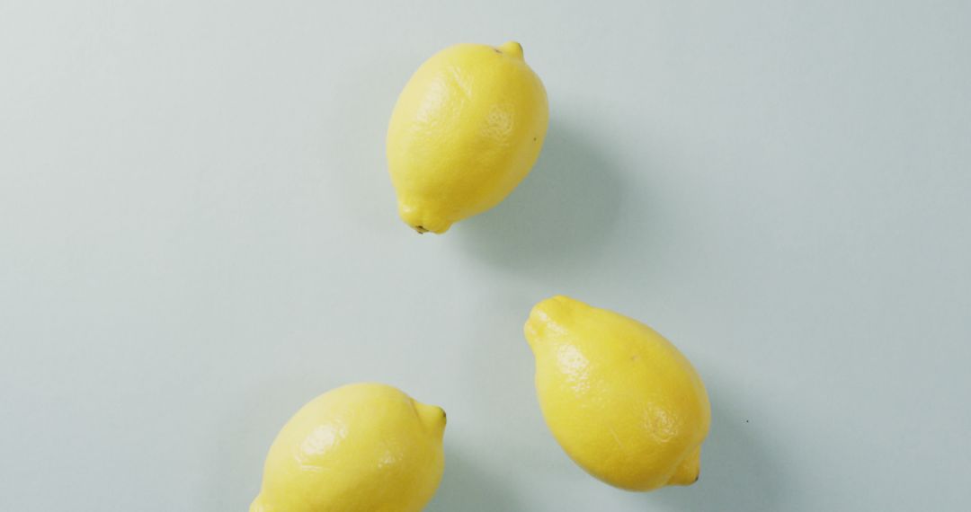 Image of fresh lemons lying on grey background - Free Images, Stock Photos and Pictures on Pikwizard.com