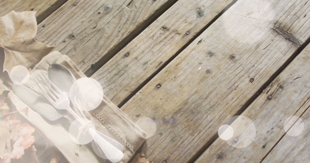 Rustic Autumn Table Setting with Cutlery and Leaves