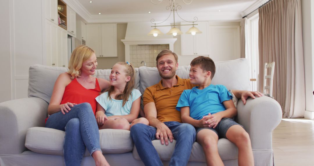 Happy Family Sitting on Couch in Bright Living Room - Free Images, Stock Photos and Pictures on Pikwizard.com