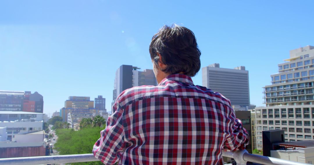 Man Admiring Cityscape From Balcony on Sunny Day - Free Images, Stock Photos and Pictures on Pikwizard.com