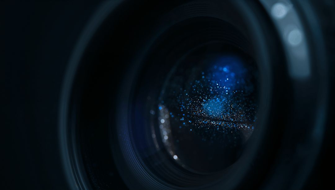 Macro Closeup Showing Blue Light Reflections Inside Camera Lens with Dust Specks and Rings