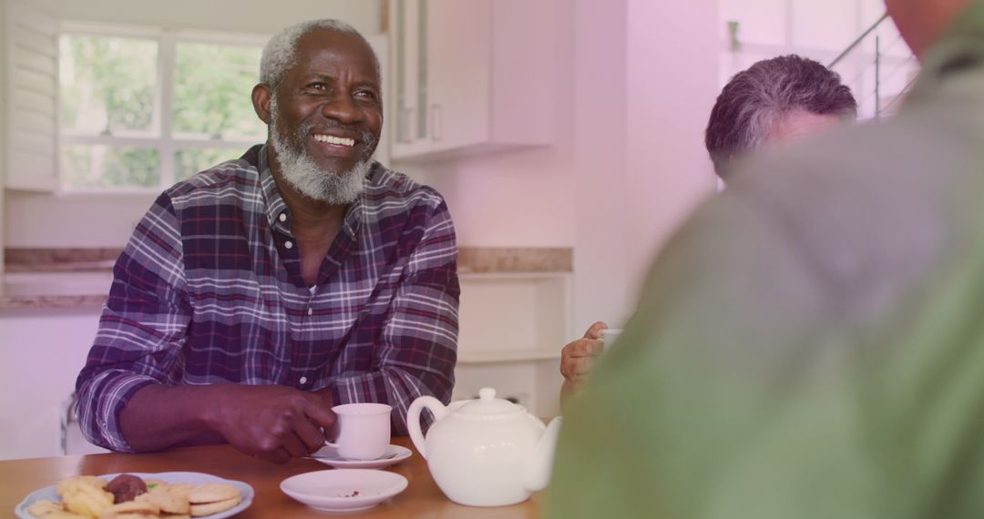 Happy Senior Group Enjoying Tea and Conversation at Home